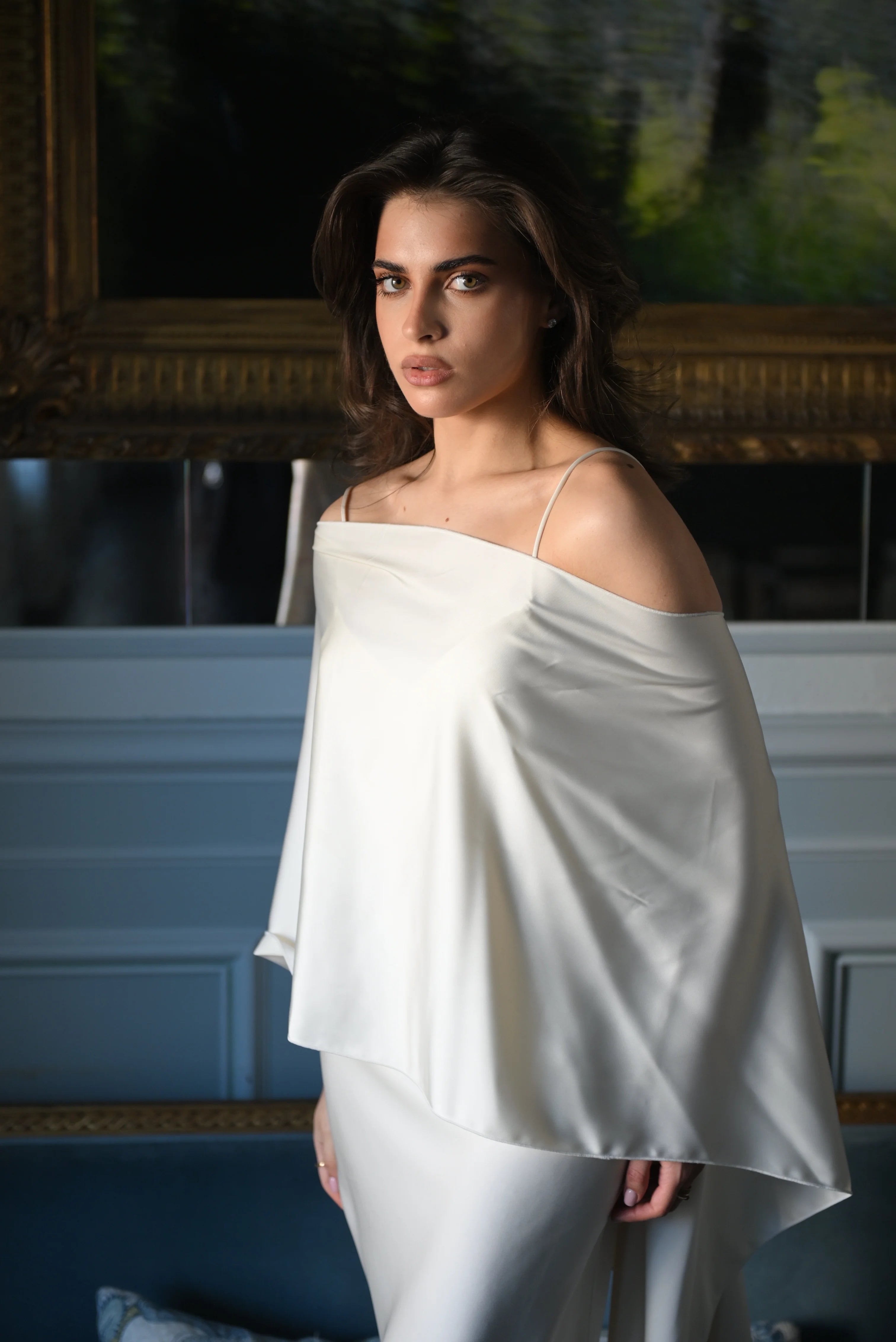 Woman wearing a white dress paired with a beautifully draped shawl