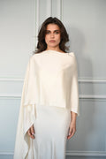 Woman wearing a white dress paired with a beautifully draped shawl