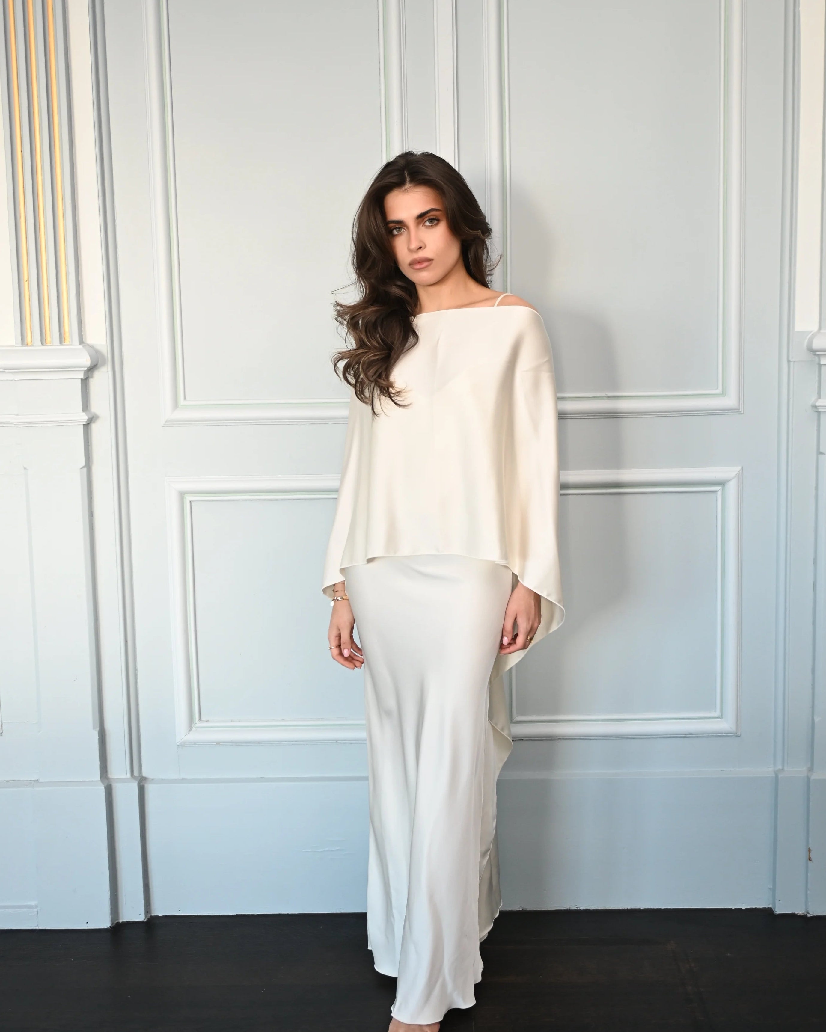 Woman wearing a white dress paired with a beautifully draped shawl