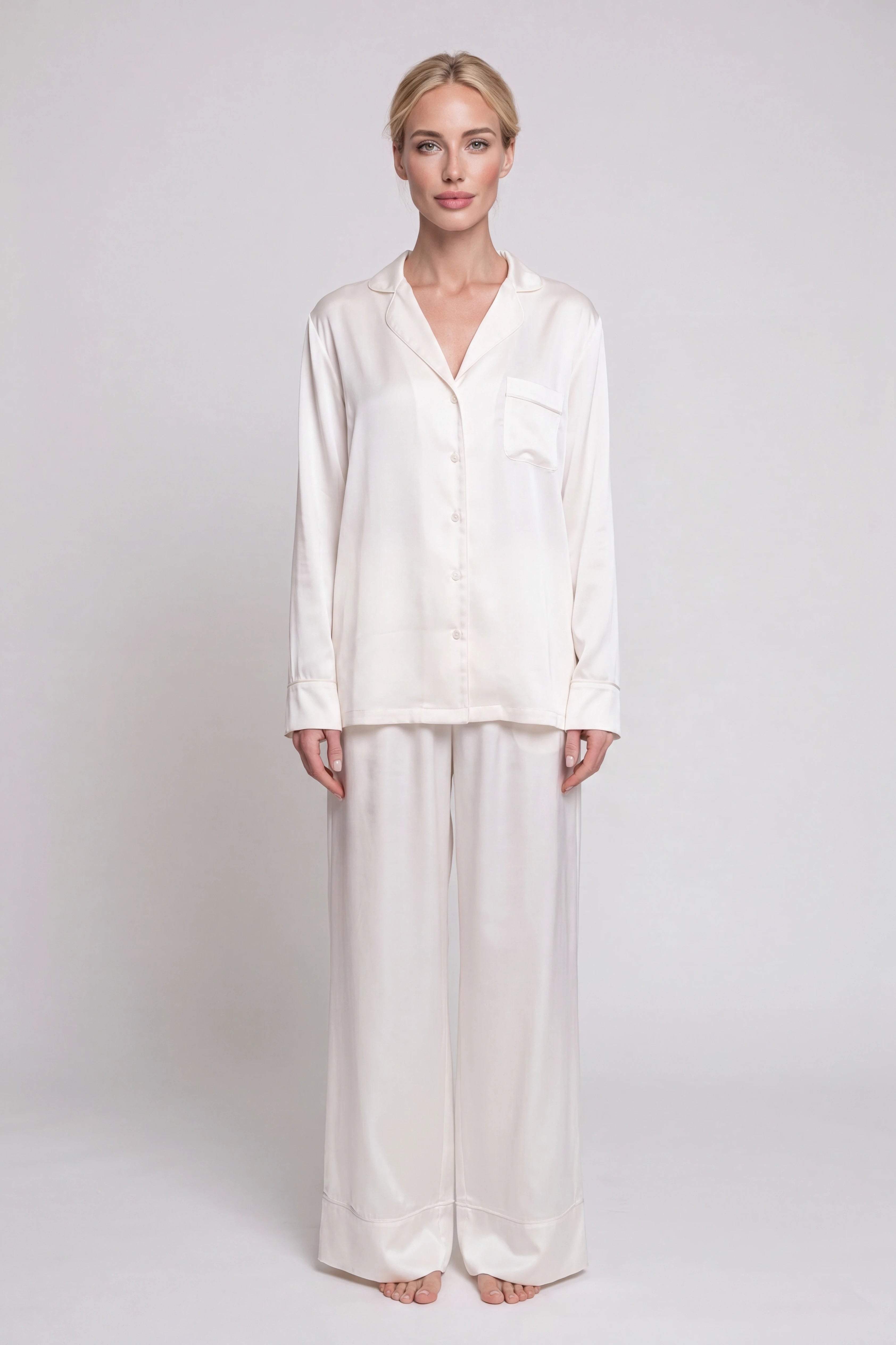 Woman wearing a white shirt and pants on a plain background